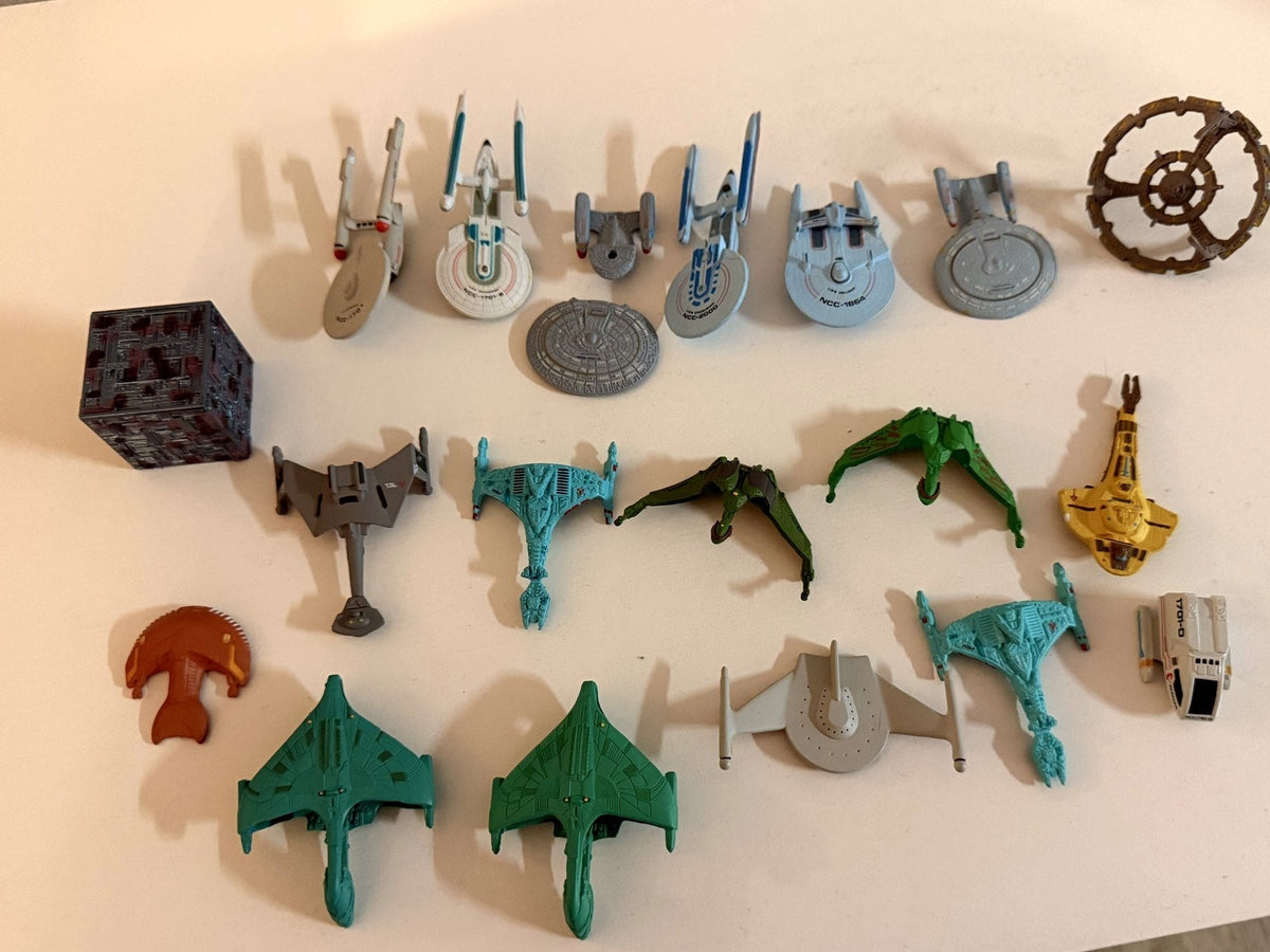 About twenty loose Galoob Star Trek Micro Machines starships grouped together