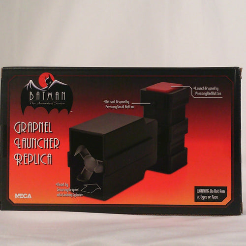 NECA Grapnel Launcher, box back showing firing and retract buttons