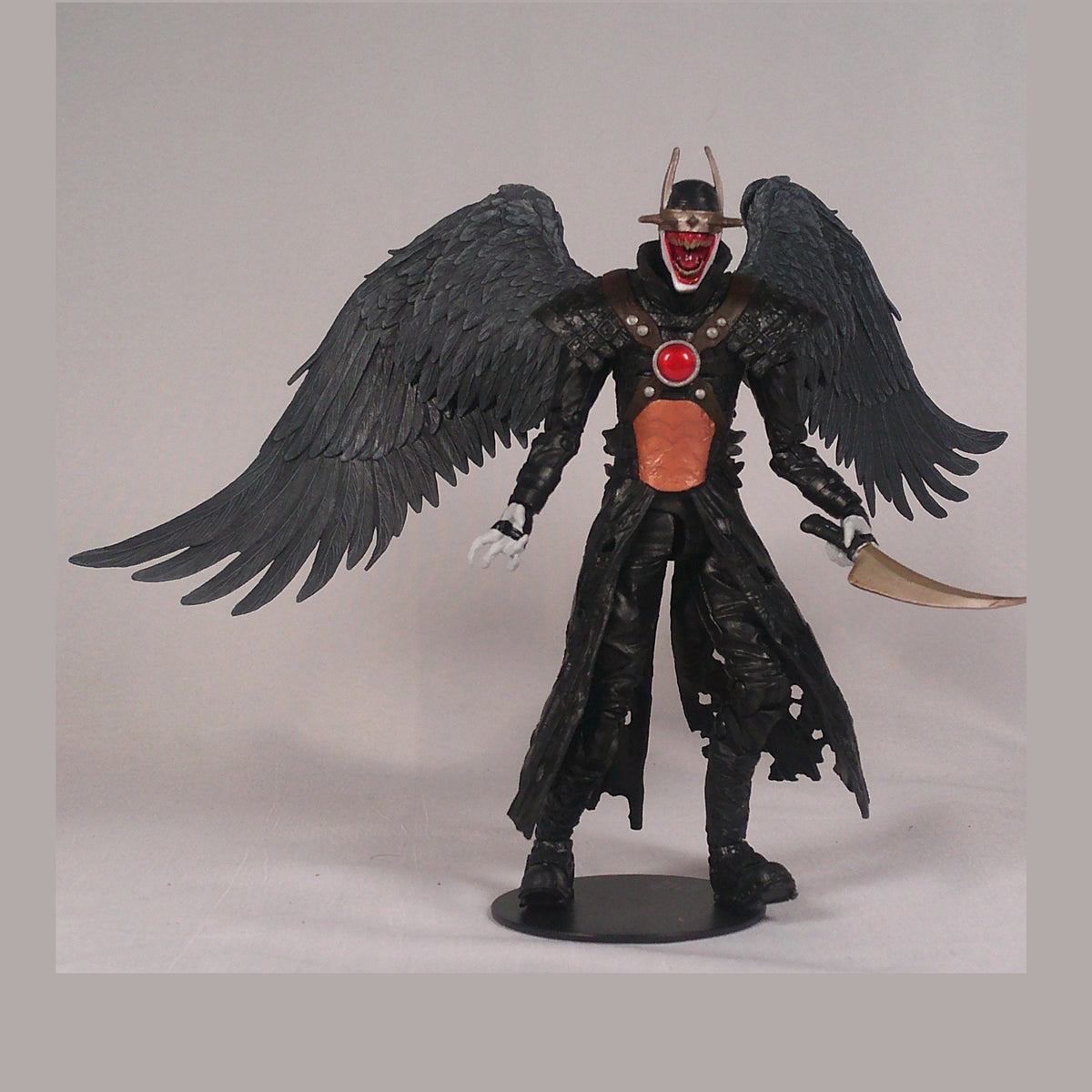 The Batman Who Laughs figure with wings spread, front view