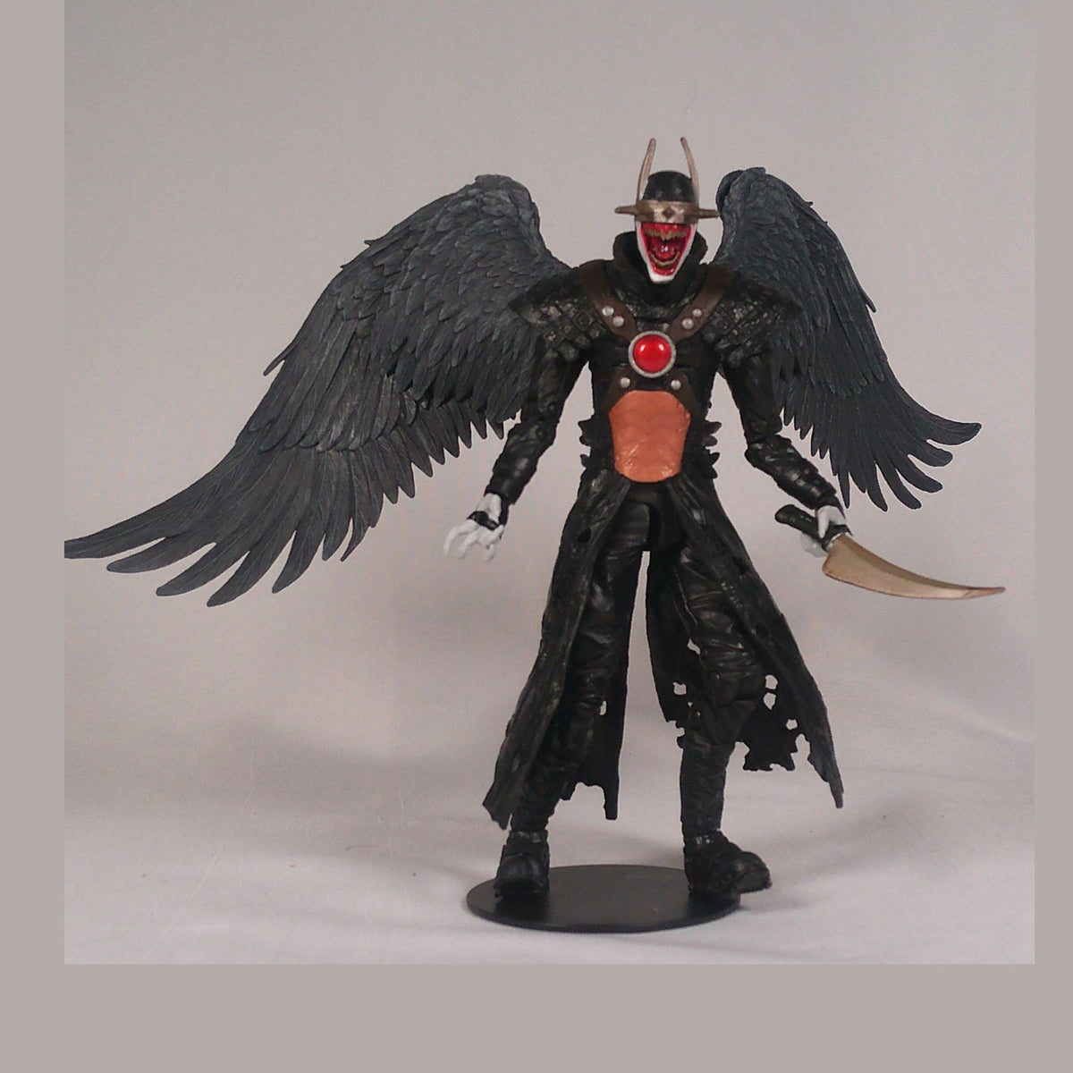 The Batman Who Laughs holding his curved blade