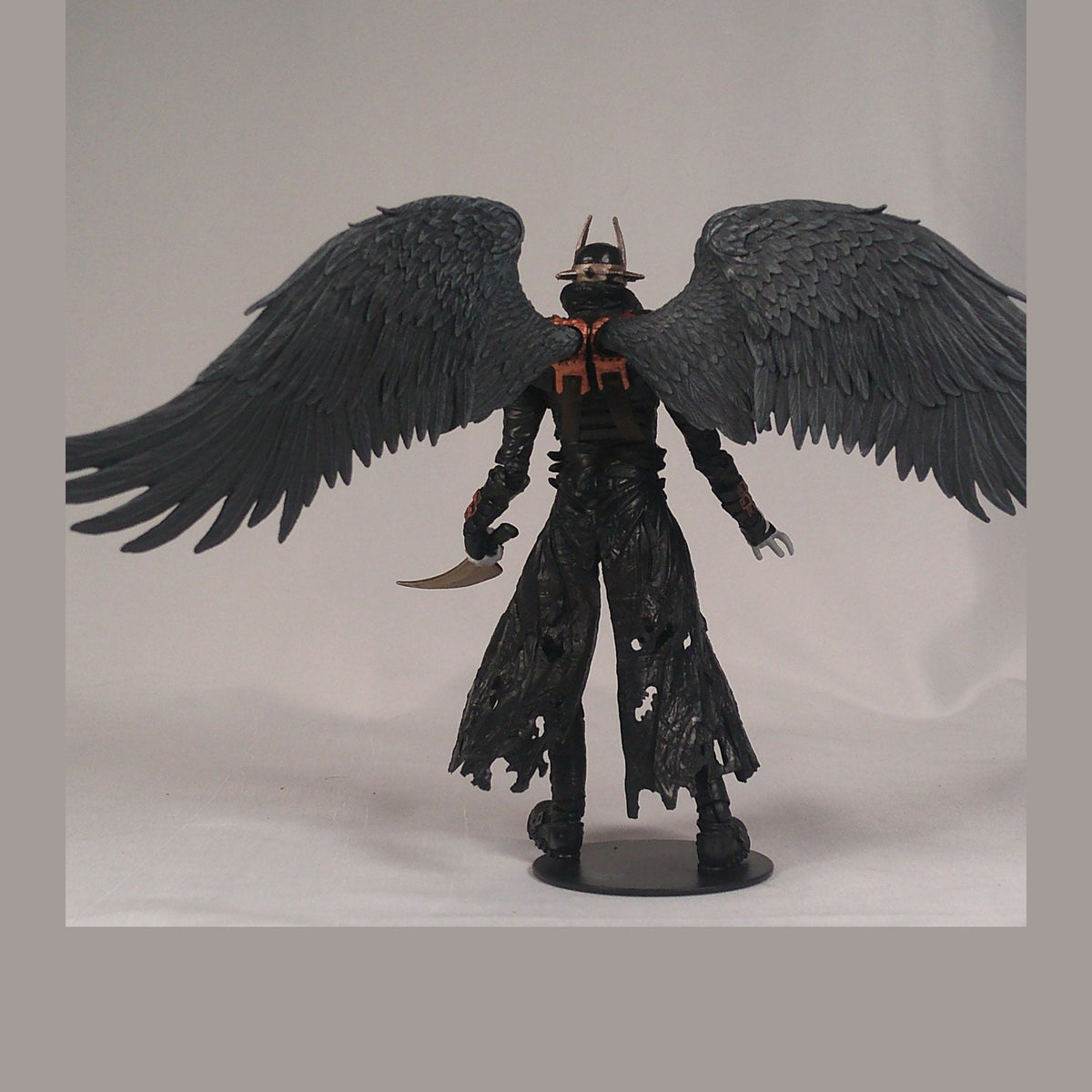 The Batman Who Laughs from behind, showing the wing sculpt