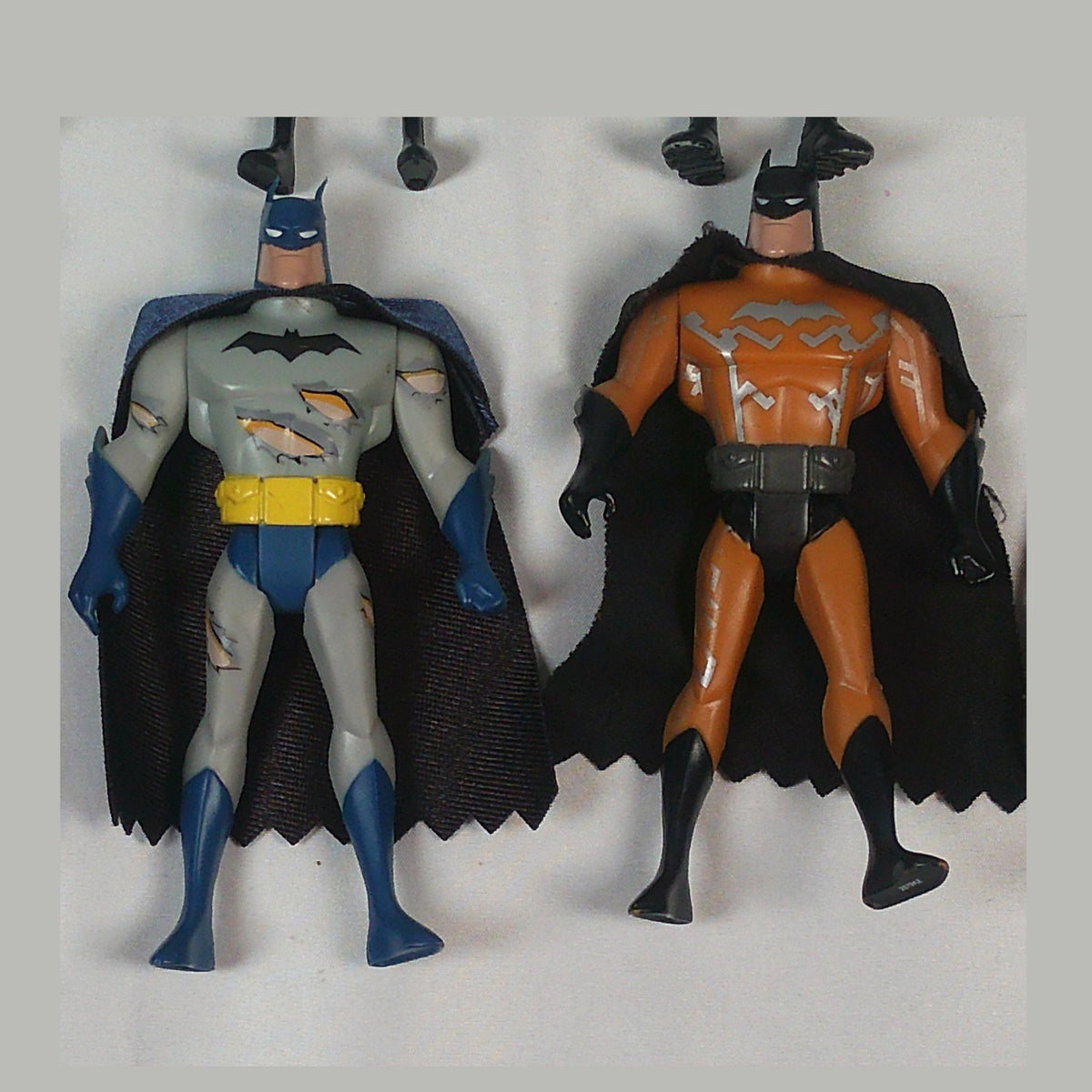 Close-up showing paint loss on two Batman figures in the lot