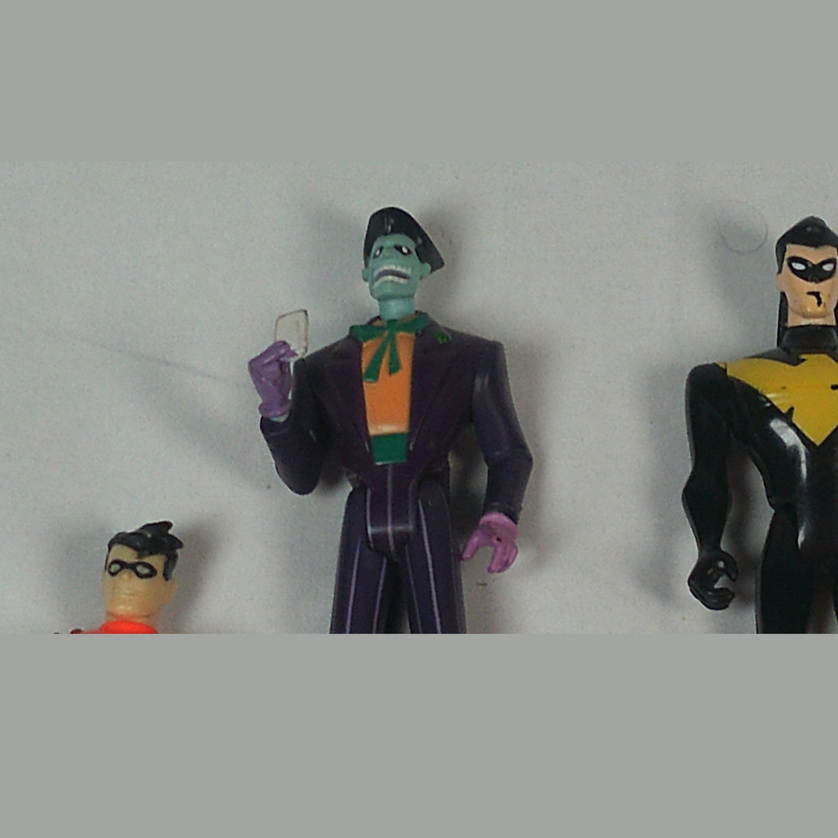 Close-up of the Joker figure with his playing card, plus Robin and Nightwing